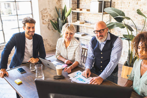 A business team discusses marketing strategies around a table.